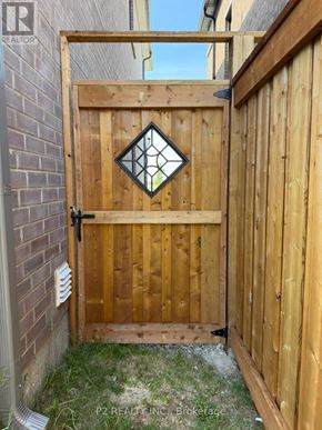 Barrie apartment for rent - A wooden gate with a diamond-shaped glass window is closed.