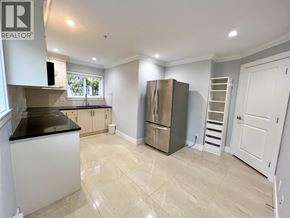Vancouver apartment for rent - A kitchen with a black countertop and a stainless steel refrigerator.