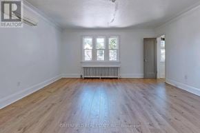 Toronto (Leaside) fourplex for rent - A room with wooden flooring and a window with white blinds.