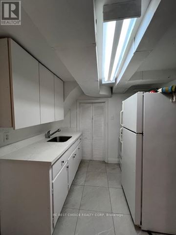 Toronto (Lansing-Westgate) apartment for rent - A kitchen with white cabinets and a white fridge.