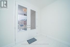 Oshawa (Samac) apartment for rent - A white door with a glass window and a mat on the floor.