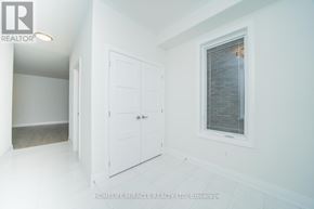 Oshawa (Samac) apartment for rent - A white room with a door and a window.