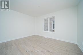 Oshawa (Samac) apartment for rent - A room with wooden flooring and a window with blinds.