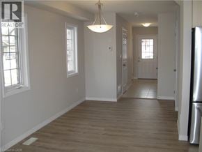 Kitchener townhouse for rent - A well lit room with wooden floors and white walls.