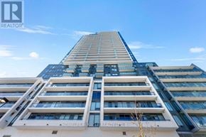 Toronto (Newtonbrook East) condo for rent - A tall building with a sign that reads "HOMELIFE MIRACLE REALTY LTD, Brokerage".