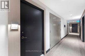 Toronto (Newtonbrook East) condo for rent - A hallway with a black door and a sign that says 2106.