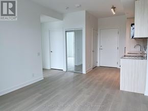 Toronto (Clairlea-Birchmount) condo for rent - A spacious room with a kitchenette and a sliding glass door.