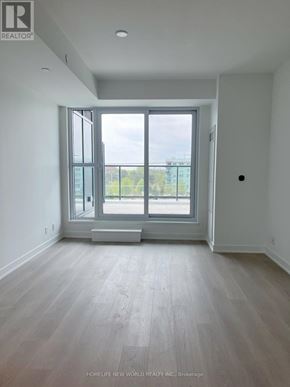 Toronto (Clairlea-Birchmount) condo for rent - A room with a large window and a wooden floor.