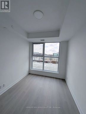 Toronto (Clairlea-Birchmount) condo for rent - A room with a large window and wooden flooring.