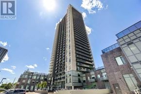 Mississauga (Hurontario) condo for rent - A tall residential building with a sunny sky in the background.