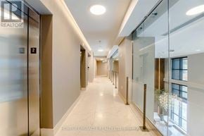 Mississauga (Hurontario) condo for rent - A hallway with glass doors and a sign that says "REALTOR".