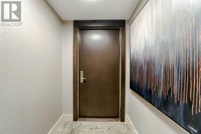 Mississauga (Hurontario) condo for rent - A hallway with a brown door and a painting on the wall.