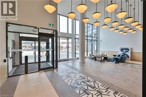 Burlington condo for rent - A large, well-lit lobby with a patterned floor and a glass door.