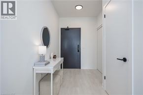Burlington condo for rent - A white table with a lamp and a book on it in a room.