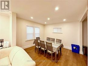 Niagara Falls (Dorchester) apartment for rent - A room with a white couch, wooden chairs, and a blue bin.