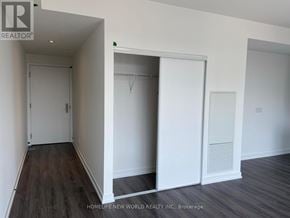 Toronto (Bay Street Corridor) condo for rent - A hallway with a white door and a white closet with a hanger.