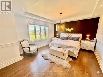 King (Nobleton) apartment for rent - A bedroom with a large bed, a chair, and a window.