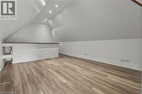 Hamilton apartment for rent - A room with wooden flooring and a stone wall.