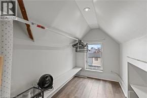 Hamilton apartment for rent - A room with a fan on a glass table and a window showing a house outside.