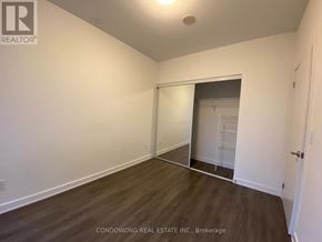 Toronto (Regent Park) condo for rent - Empty room with a sliding door leading to another room.