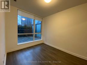 Toronto (Regent Park) condo for rent - Empty room with a window and a wooden floor.