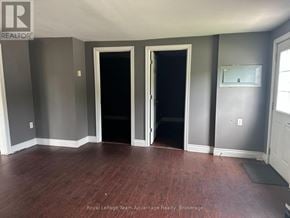 Parry Sound apartment for rent - A room with two doors and a mirror on the wall.