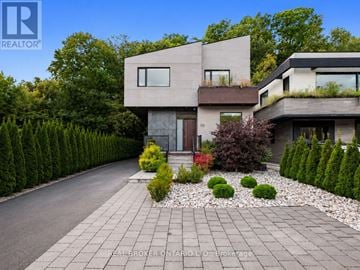 Toronto (High Park-Swansea) apartment for rent - A modern house with a grey front yard and a driveway.