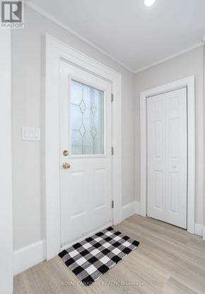 Hamilton (Hill Park) apartment for rent - A white door with a glass window and a black and white checkered mat in front of it.