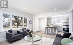 Hamilton (Hill Park) apartment for rent - A modern living room with a glass coffee table and grey couches.