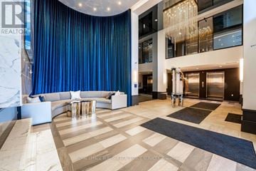 Grimsby (Grimsby Beach) condo for rent - A spacious living room with a curved blue wall and a chandelier.