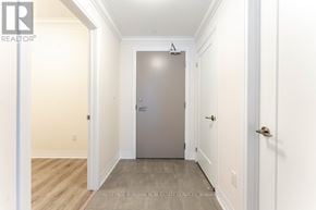 Grimsby (Grimsby Beach) condo for rent - A hallway with a door at the end and a broker logo on the wall.