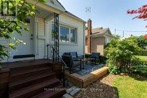 St. Catharines (Downtown) apartment for rent - A house with a white exterior and a wooden deck.