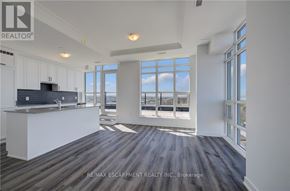 Hamilton (Lakeshore) condo for rent - A spacious kitchen and living room with a view of the city.