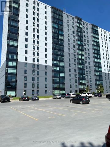 London South (South J) condo for rent - A parking lot in front of a tall building.