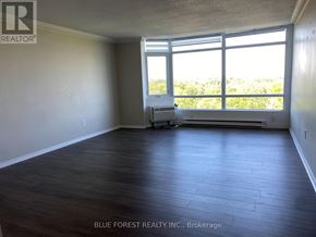 London South (South J) condo for rent - A room with a large window and a view of trees outside.