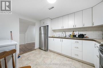 Pickering (Woodlands) apartment for rent - A kitchen with white cabinets and a stainless steel refrigerator.