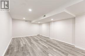 Burlington (Lasalle) apartment for rent - A spacious room with wooden flooring and white walls.