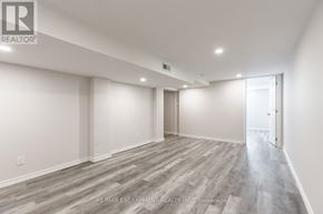 Burlington (Lasalle) apartment for rent - A spacious room with wooden flooring and white walls.