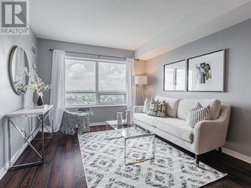 Toronto (Junction Area) condo for rent - A living room with a white couch and a large window.