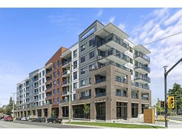 Langley apartment for rent - A modern multi-story apartment building with balconies and a mix of brick and panel exteriors.