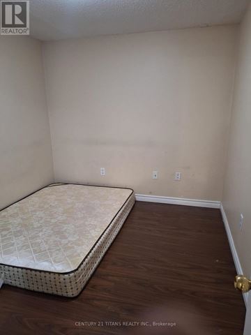 Markham (Cedarwood) townhouse for rent - A bedroom with a bed and a wooden floor.