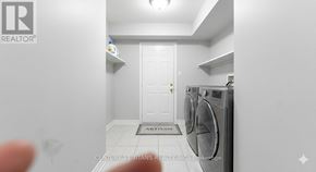 Markham (Cedarwood) townhouse for rent - A laundry room with a washer and dryer.