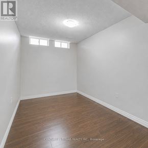Markham (Cedarwood) townhouse for rent - A room with wooden flooring and white walls.
