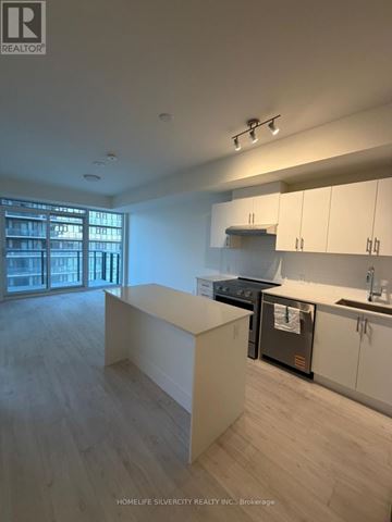 Vaughan (Vellore Village) condo for rent - A modern kitchen with white cabinets and a stainless steel oven.