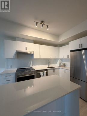 Vaughan (Vellore Village) condo for rent - A modern kitchen with white cabinets and stainless steel appliances.