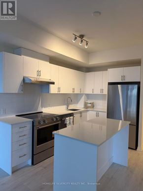 Vaughan (Vellore Village) condo for rent - A modern kitchen with white cabinets and a central island.