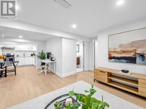 Toronto (Wexford-Maryvale) apartment for rent - A well-lit, spacious living room with a dining area and a kitchen in the background.
