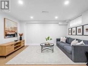 Toronto (Wexford-Maryvale) apartment for rent - A living room with a grey couch, a coffee table, and a painting on the wall.
