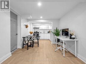 Toronto (Wexford-Maryvale) apartment for rent - A well-lit, modern kitchen and dining area with a wooden floor and white walls.