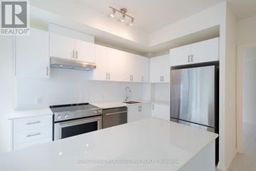 Vaughan (Vellore Village) condo for rent - A white kitchen with a stainless steel refrigerator and oven.